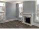 Living room featuring hardwood floors, fireplace, and shuttered windows at 3021 Stone Mountain St, Lithonia, GA 30058