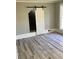 Bedroom with barn door and hardwood floors at 3021 Stone Mountain St, Lithonia, GA 30058