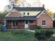Brick house with a yellow side, wooden porch and fenced yard at 3021 Stone Mountain St, Lithonia, GA 30058