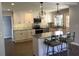 Updated kitchen with granite countertops, white cabinets, and an island at 3021 Stone Mountain St, Lithonia, GA 30058