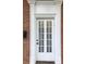 White front door with glass panes and detailed trim at 3021 Stone Mountain St, Lithonia, GA 30058