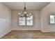 Bright dining room with chandelier and hardwood floors at 58 Longhorn Way, Auburn, GA 30011