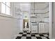 Small kitchen with white cabinets and black and white floor at 17 Avery Ne Dr, Atlanta, GA 30309