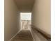 View of carpeted stairs leading down to a finished basement with wood-look flooring at 27 Longhorn Way, Auburn, GA 30011