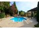 Inviting in-ground swimming pool with a pergola and lounge chairs at 825 Cotton Creek Dr, Canton, GA 30115