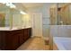 Elegant bathroom with double vanity, large mirror, and a separate shower and tub at 825 Cotton Creek Dr, Canton, GA 30115