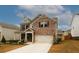 Two-story brick house with front porch and driveway at 1840 Wellston Dr, Lawrenceville, GA 30043