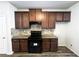 Modern kitchen with granite countertops and dark brown cabinets at 1535 Iris Walk, Jonesboro, GA 30238