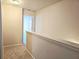 Upstairs hallway with neutral walls and carpeted floors at 1535 Iris Walk, Jonesboro, GA 30238