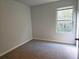 Bright bedroom with carpeted floor and a large window at 1535 Iris Walk, Jonesboro, GA 30238