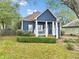 Charming blue house with white columns, landscaping, and a well-maintained lawn at 3267 Elm St, Atlanta, GA 30337