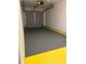 Garage with grey epoxy floor and yellow trim at 2688 Landington Way, Duluth, GA 30096