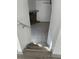 Stairs leading down to a tiled lower level with a stone fireplace at 2688 Landington Way, Duluth, GA 30096