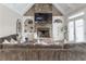 Spacious Gathering room with a stone fireplace and built-in shelving at 3960 Carissa Trce, Cumming, GA 30040