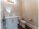 Stylish powder room features a gray vanity and a round mirror at 3960 Carissa Trce, Cumming, GA 30040