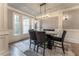 Formal dining room with marble table, chandelier, and hardwood floors at 3960 Carissa Trce, Cumming, GA 30040