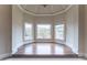 Sunlit sitting area with hardwood floors and large windows at 3960 Carissa Trce, Cumming, GA 30040