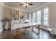 Home office with built-in shelving, desk, and hardwood floors at 3960 Carissa Trce, Cumming, GA 30040