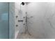 Luxurious shower with marble tile, multiple shower heads, and built-in seat at 3960 Carissa Trce, Cumming, GA 30040