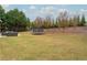 Large backyard with trampoline and patio furniture at 3960 Carissa Trce, Cumming, GA 30040
