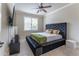 Comfortable bedroom with plush bed, window seating, and mounted TV at 3960 Carissa Trce, Cumming, GA 30040