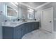 Elegant bathroom with dual vanities, gray cabinets, and marble floors at 3960 Carissa Trce, Cumming, GA 30040