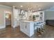 Gourmet kitchen boasts white cabinetry, marble countertops, and a large island at 3960 Carissa Trce, Cumming, GA 30040