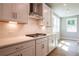 Modern kitchen with white cabinets, stainless steel appliances, and quartz countertops at 7620 Woolf Way, Cumming, GA 30028