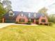 Brick house with a large yard and a two-car garage at 880 Streamside Dr, Mcdonough, GA 30252