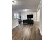 Bright living room with gray sofas, a large TV, and wood-look flooring at 6185 Bermuda St, Forest Park, GA 30297