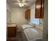 Bright laundry room with washer, dryer, and cabinets at 2194 Klondike Sw Rd, Conyers, GA 30094