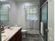Bathroom with double vanity, a shower, and wood cabinets at 2194 Klondike Sw Rd, Conyers, GA 30094
