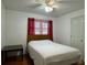 Bedroom with wood flooring, a double bed, and red curtains at 2194 Klondike Sw Rd, Conyers, GA 30094