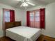 Bedroom with hardwood floors, a double bed, and red curtains at 2194 Klondike Sw Rd, Conyers, GA 30094