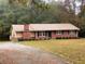 Brick ranch house with a large yard and driveway at 2194 Klondike Sw Rd, Conyers, GA 30094