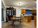 Kitchen and dining area with wood cabinets and flooring, and a wooden dining set at 2194 Klondike Sw Rd, Conyers, GA 30094
