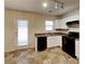 Modern kitchen with white cabinets, black appliances, and tile floor at 508 Brady Dr, Villa Rica, GA 30180