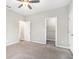 Spacious bedroom with neutral walls and carpet, featuring a ceiling fan and ample closet space at 400 Bass Sw St, Atlanta, GA 30310