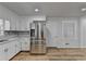 Modern kitchen with stainless steel refrigerator and white cabinets at 1365 Renee Dr, Decatur, GA 30035