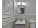 Clean bathroom with white tiled walls and a vanity with sink at 1365 Renee Dr, Decatur, GA 30035