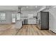 Modern kitchen featuring stainless steel appliances and light wood flooring at 1365 Renee Dr, Decatur, GA 30035