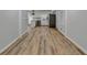 Long hallway with light wood flooring connecting rooms at 1365 Renee Dr, Decatur, GA 30035