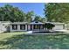 Charming ranch house with white brick exterior, black trim, and a manicured lawn at 1365 Renee Dr, Decatur, GA 30035