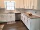 Modern kitchen with white cabinets, granite countertops, and luxury vinyl plank flooring at 2961 Hawk Se Ct, Marietta, GA 30067