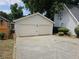 Two-car garage with driveway and landscaping at 2961 Hawk Se Ct, Marietta, GA 30067