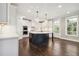 Modern kitchen featuring white cabinets, large island, and stainless steel appliances at 6108 Hutchins Dr, Buford, GA 30518