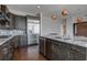 Modern kitchen with island, dark cabinetry and granite countertops at 1065 Peachtree Ne St # 3201, Atlanta, GA 30309