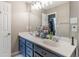 Double vanity bathroom with gray cabinets and a large mirror at 215 Mackenzie Ct, Canton, GA 30115