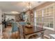 Bright dining area with a rustic wooden table and light-green cabinets at 215 Mackenzie Ct, Canton, GA 30115