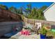 Stone patio with fire pit and seating area, surrounded by a fenced yard at 215 Mackenzie Ct, Canton, GA 30115